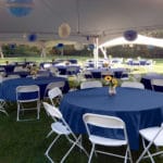 Party tent filled with decorated tables and chairs