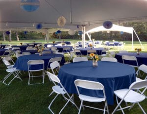 Party tent filled with decorated tables and chairs